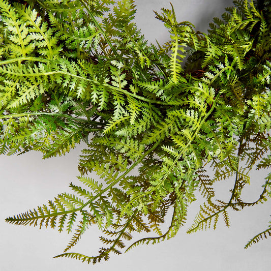 18" faux fern wreath, closeup view, with gray background.