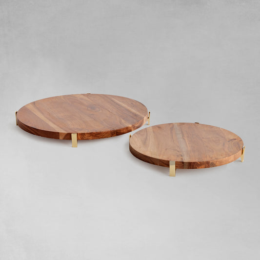 Acacia wood round serving board front view with gray background.