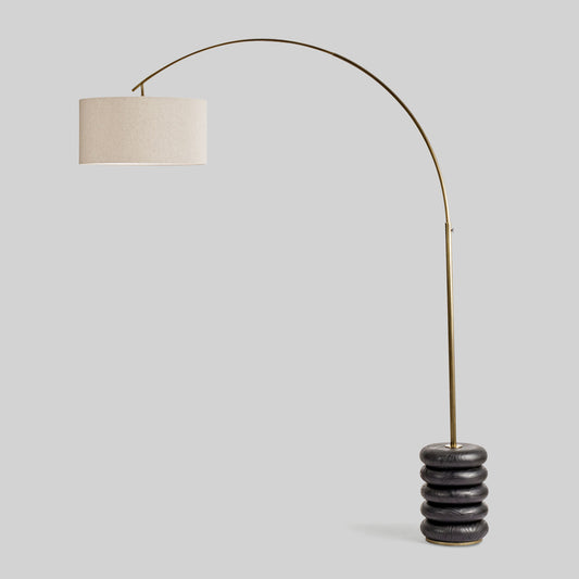 Floor lamp with a curved arm and wooden base on a light gray background.