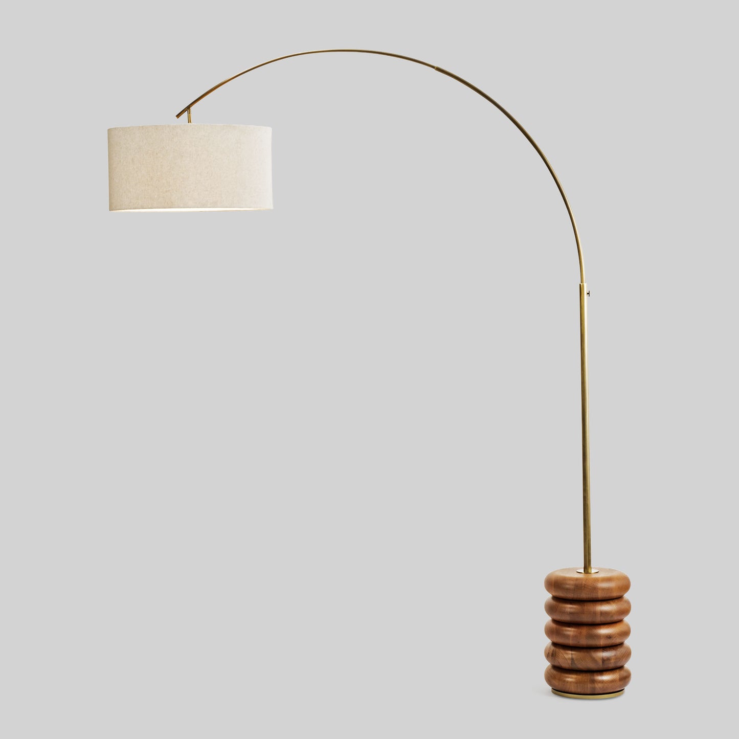 Floor lamp with a curved arm and wooden base on a light gray background.