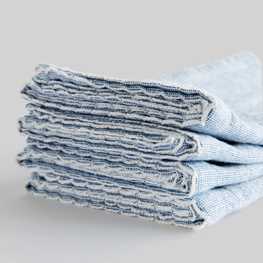 Blue scalloped square cotton dinner napkins set of 4, closeup view of edge detail.