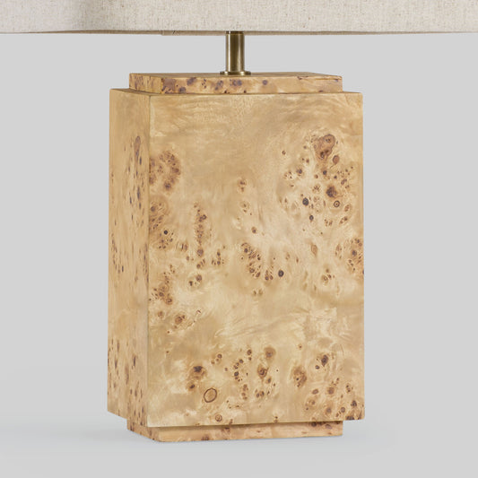 Burl wood table lamp on a light gray background.