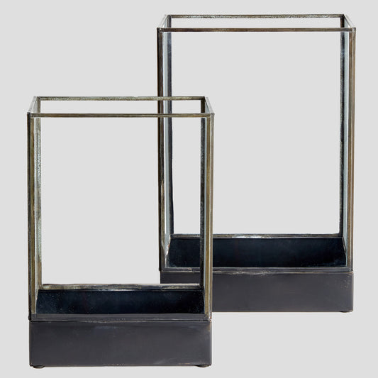Brass and glass hurricane candle holder in black small/large with light gray background.