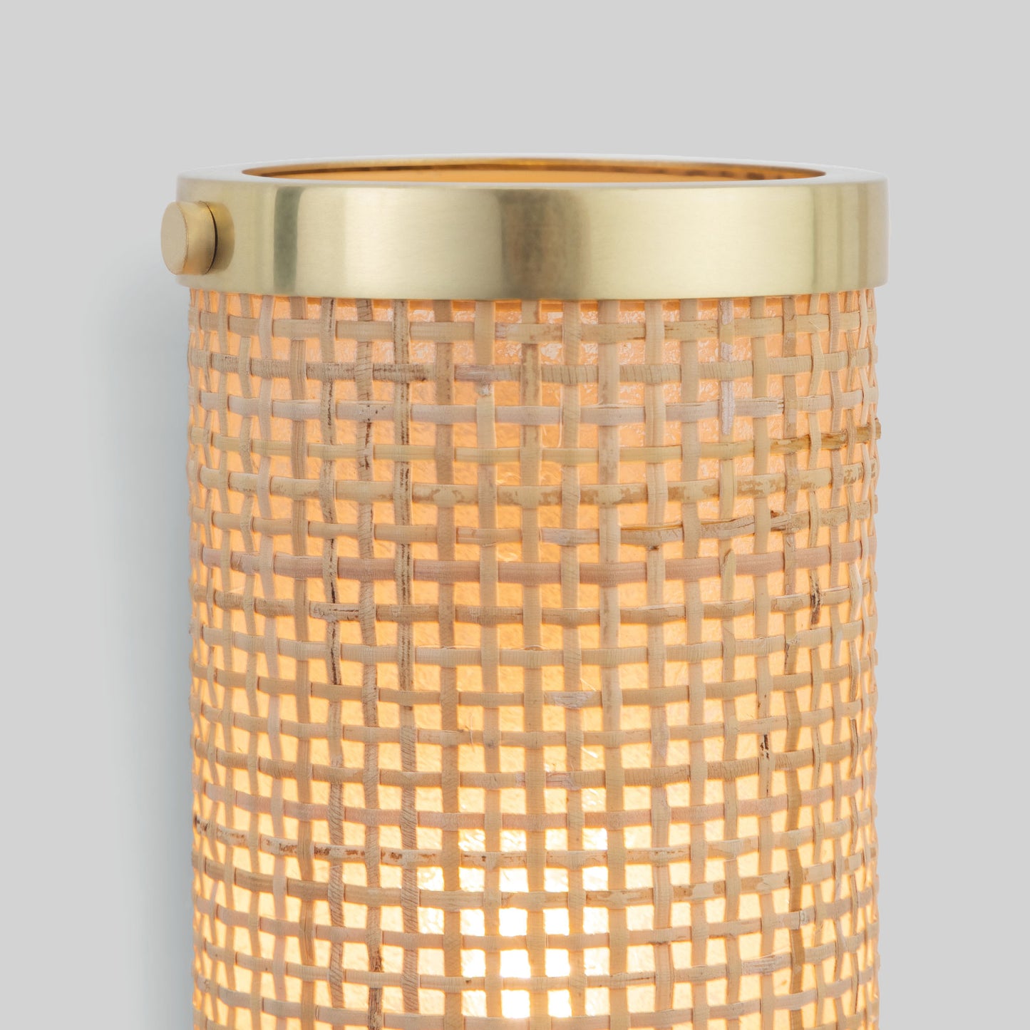 Wall-mounted light fixture with gold trim and textured glass on a gray background.