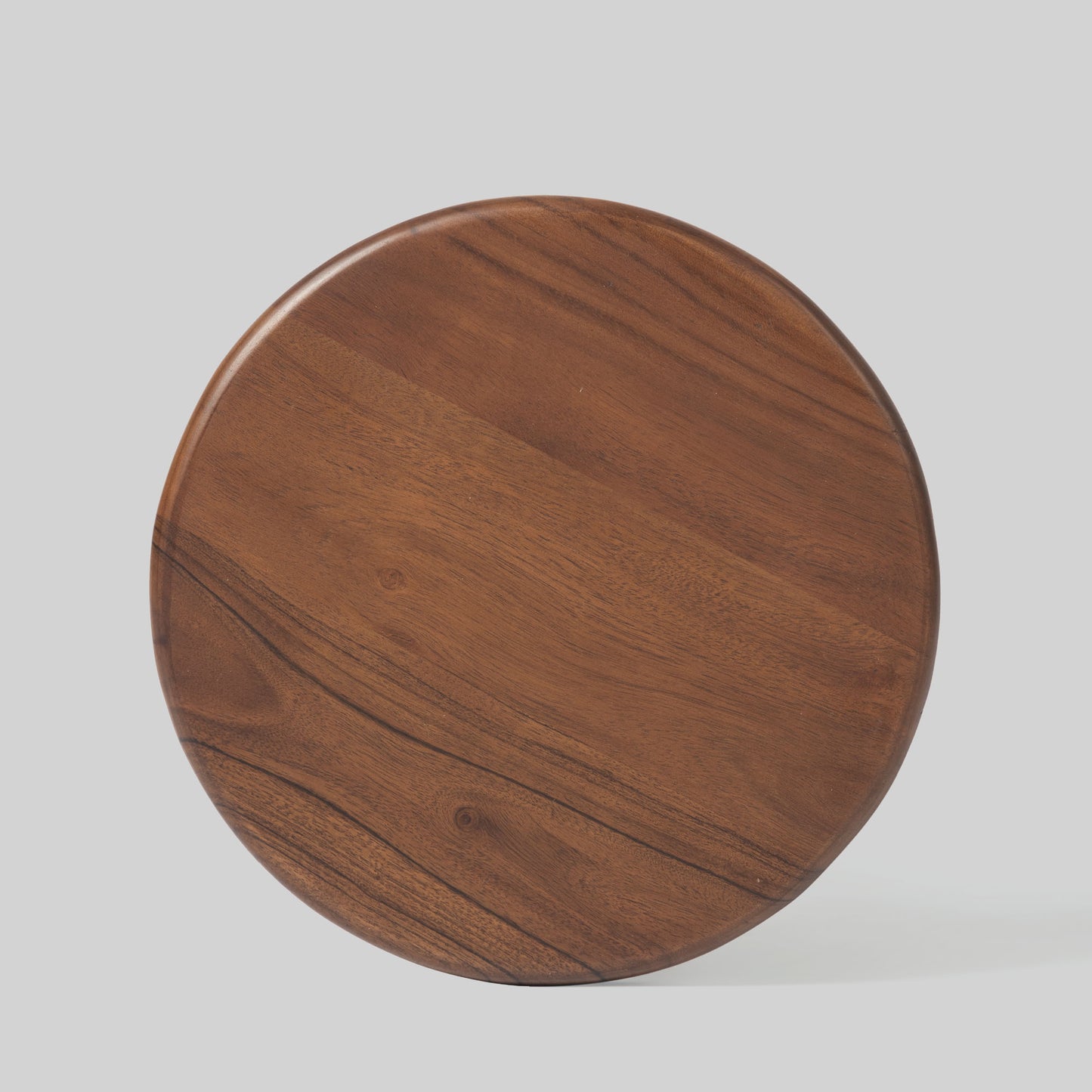 Round wooden side table with spindle design on a light gray background.
