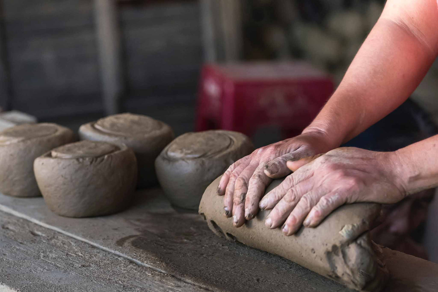 Chinese woman preparing clay for mold.