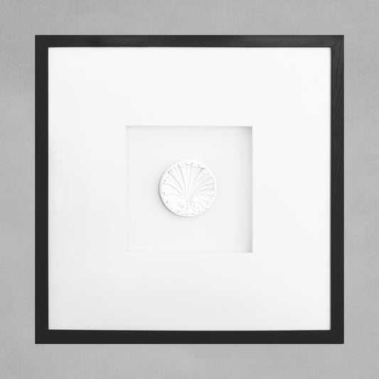 Contemporary framed art deco colonial shell artwork, black picture frame, with gray background.