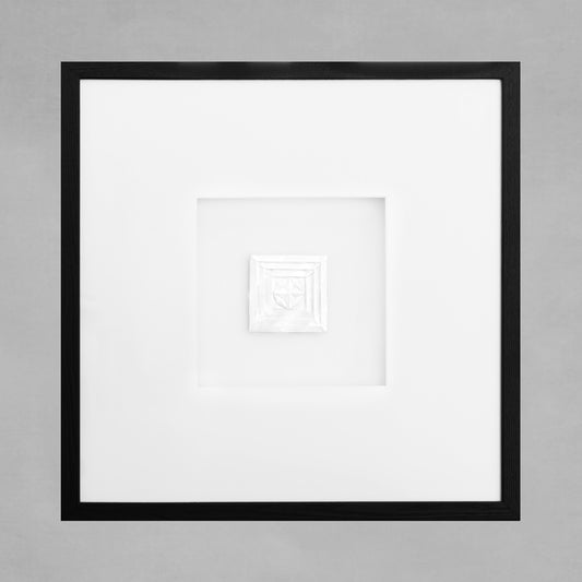 Contemporary framed art deco square artwork with black frame on gray background.