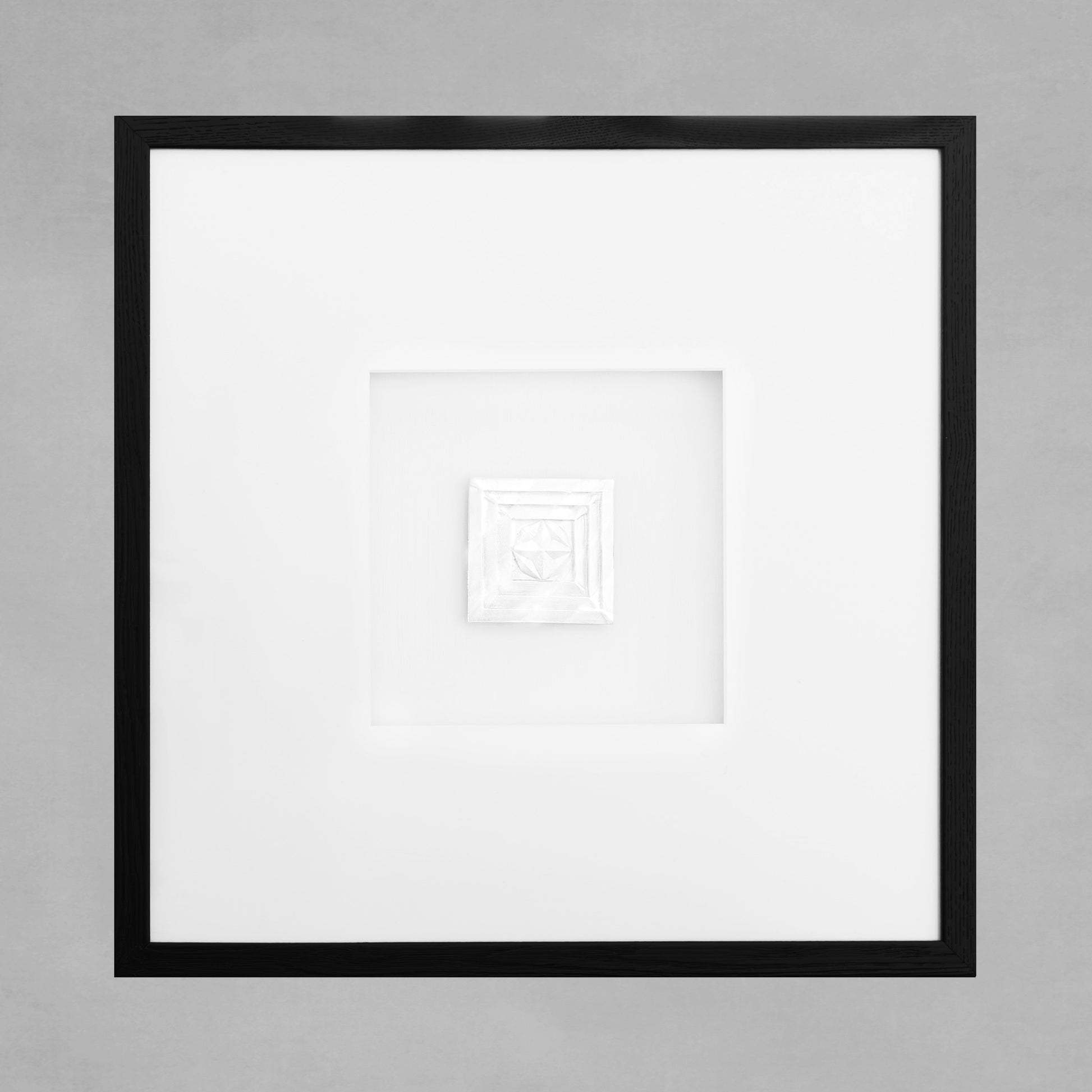 Contemporary framed art deco square artwork with black frame on gray background.