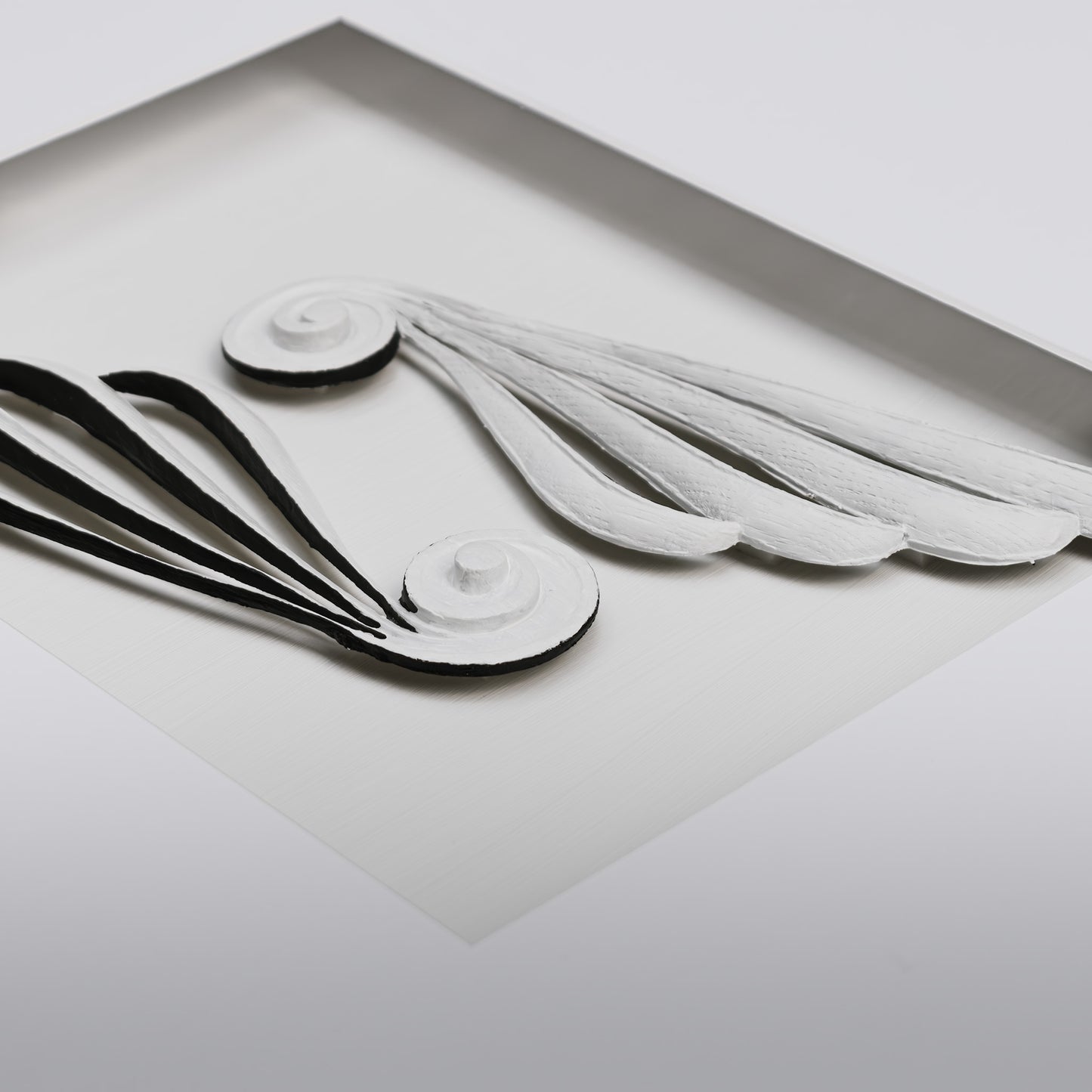 Contemporary framed Greek scroll wings artwork closeup.