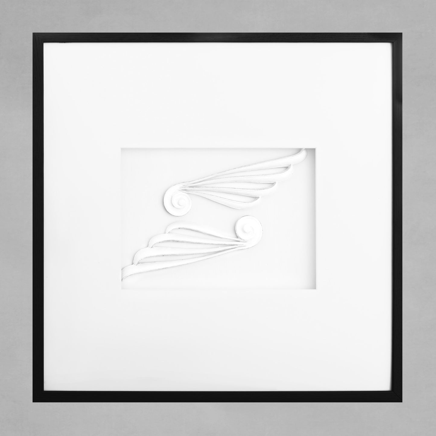 Contemporary framed Greek scroll wings artwork with white mat and black wooden frame.