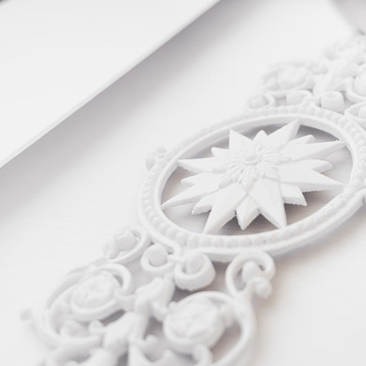 Contemporary framed sunburst rosette artwork closeup.