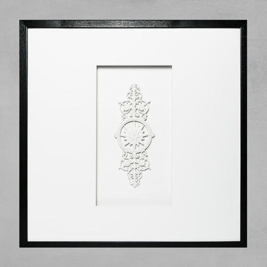 Contemporary framed sunburst rosette artwork with white mat and black wooden frame.