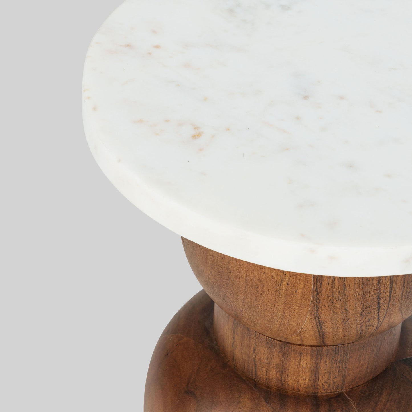 Wooden side table with marble top on a light gray background.