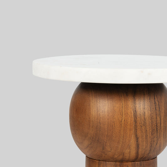 Side table with wooden base and white marble top on a gray background.