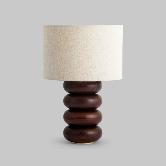 Contemporary stacked wood ring table lamp with walnut finish.
