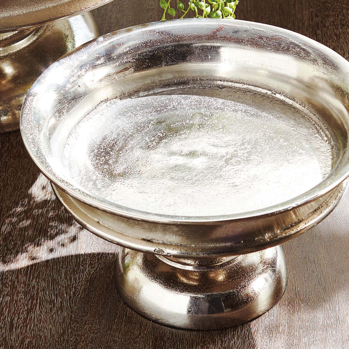 Decorative brushed nickel pedestal, closeup view.