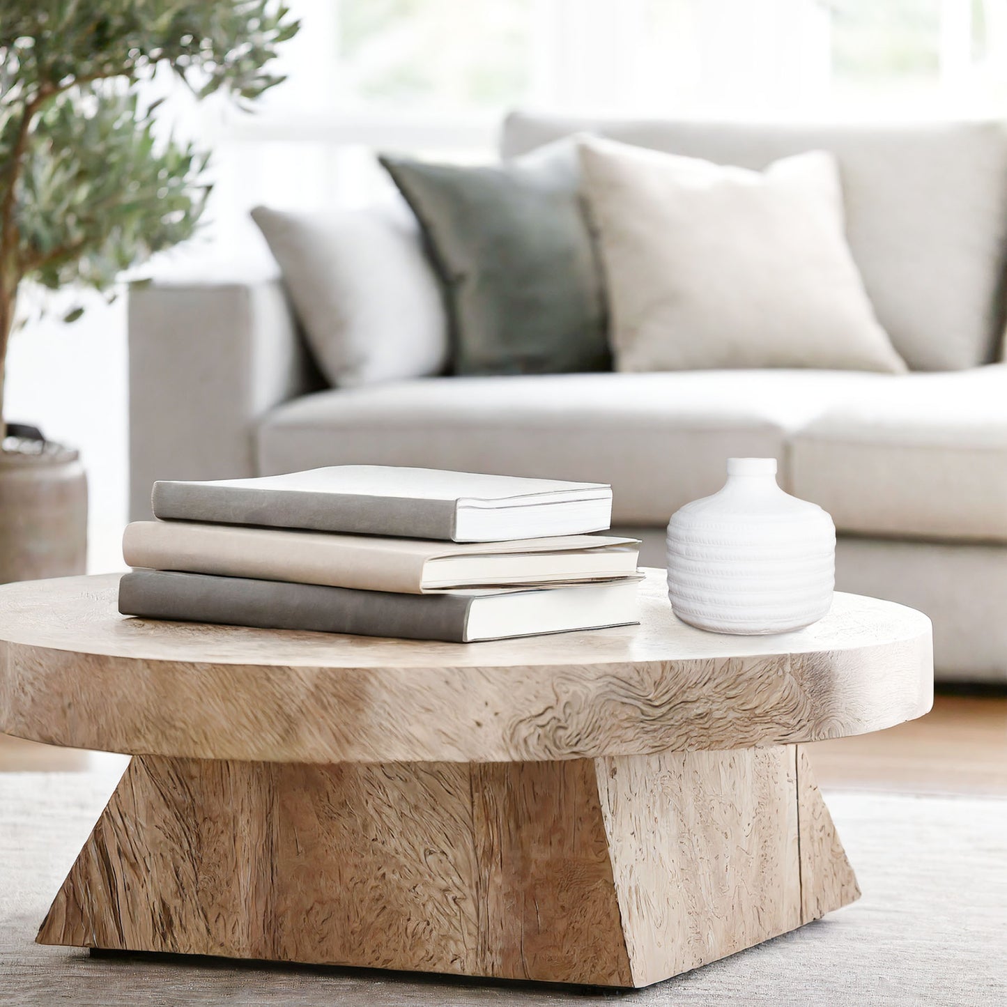 Decorative ceramic white vase with textured banding on coffee table in living room.