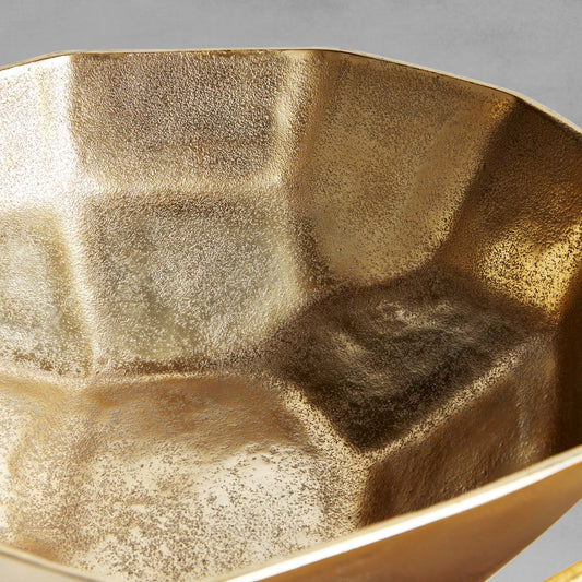 Decorative gold geometric bowls, closeup interior view, with gray background.