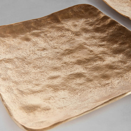 Decorative square metal trays, set of 3, closeup view, with gray background.