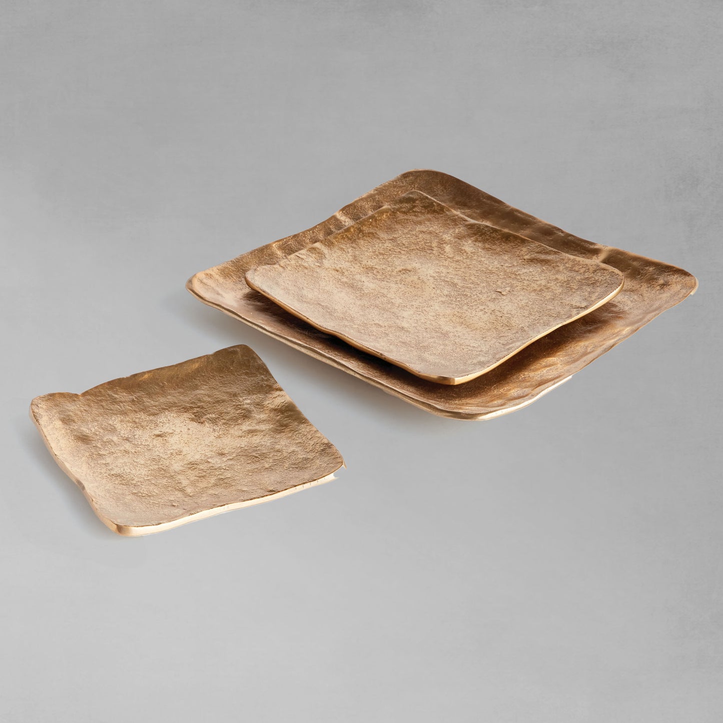 Decorative square metal trays, set of 3, arranged with gray background.