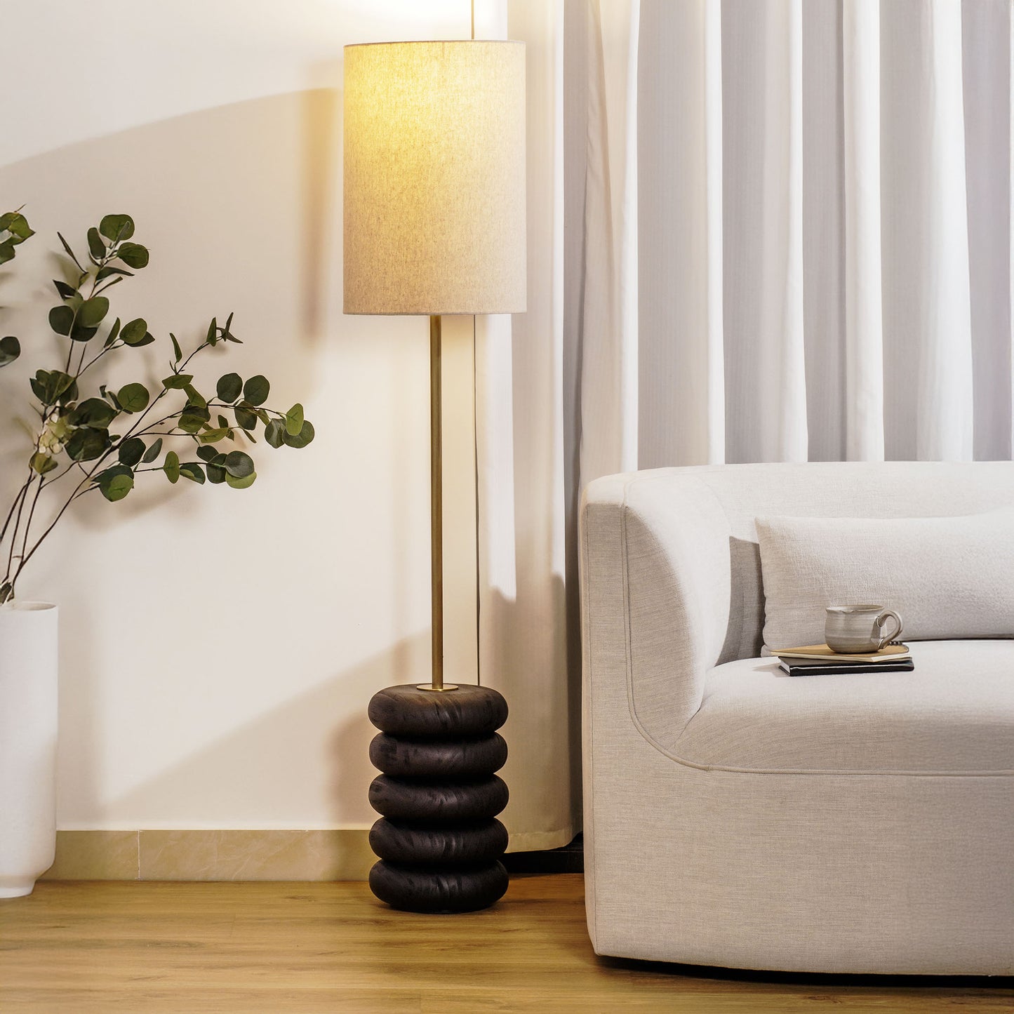 Floor lamp with a stacked circular wood base stylized in living room.