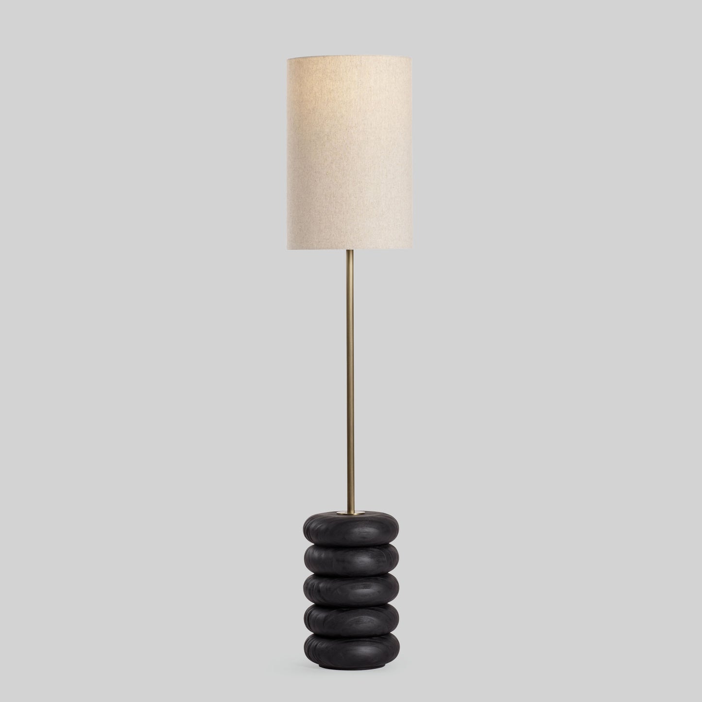 Floor lamp with a stacked circular wood base on a light gray background.