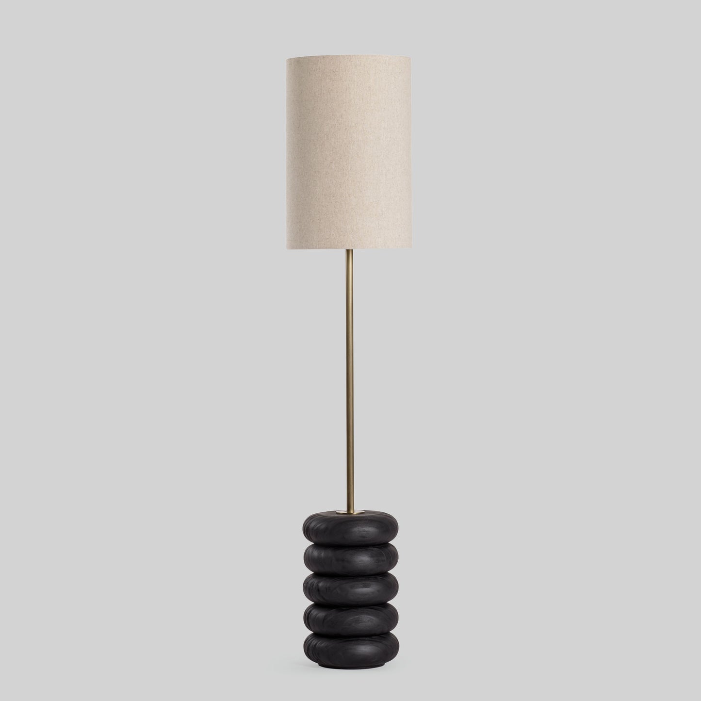 Floor lamp with a stacked circular wood base on a light gray background.