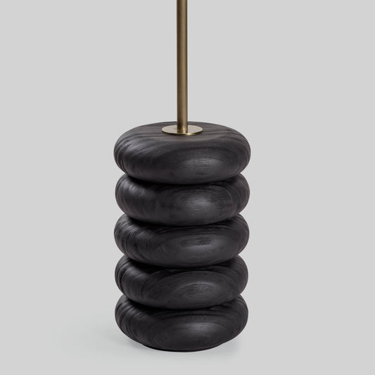 Floor lamp with a stacked circular wood base on a light gray background.