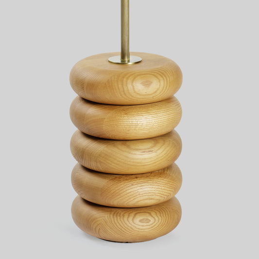 Floor lamp with a stacked circular wood base on a light gray background.