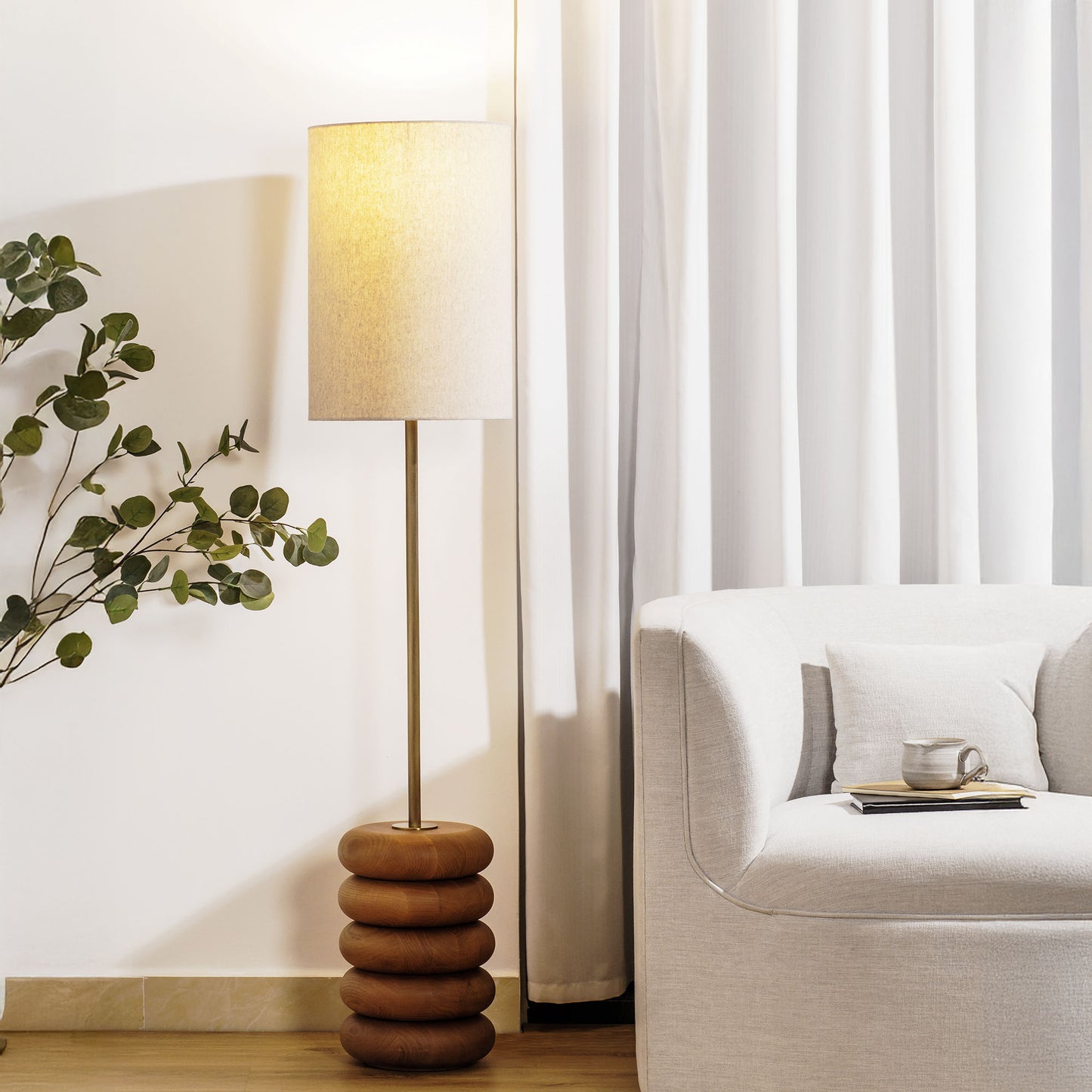 Floor lamp with a stacked circular wood base stylized in living room.