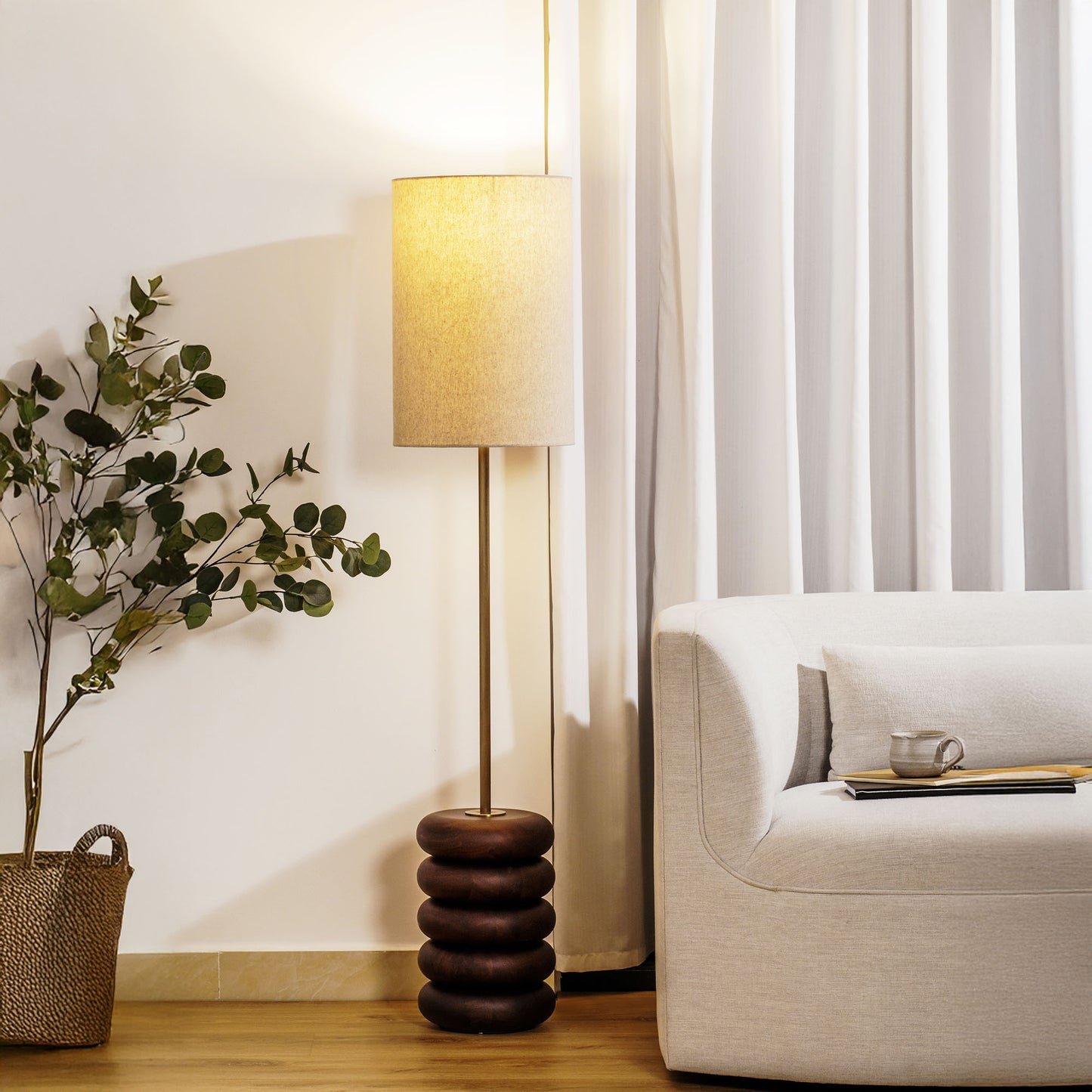 Floor lamp with a stacked circular wood base stylized in living room.