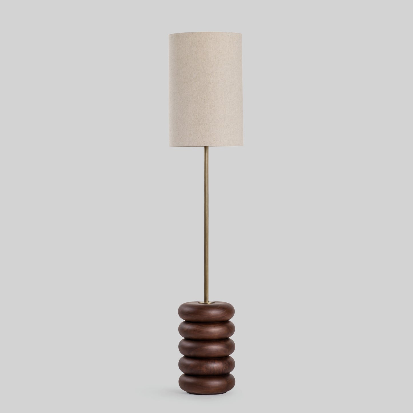 Floor lamp with a stacked circular wood base on a light gray background.