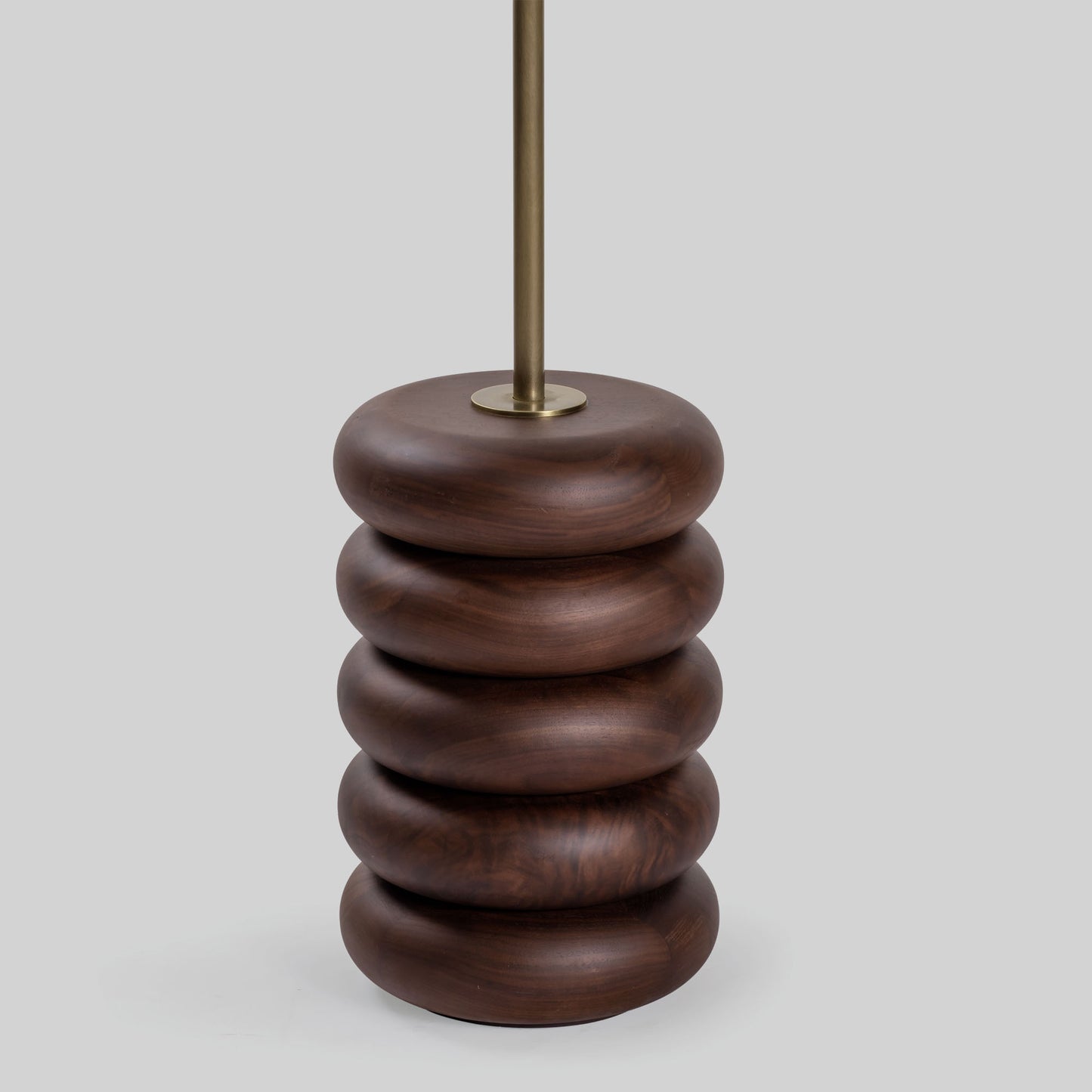 Floor lamp with a stacked circular wood base on a light gray background.
