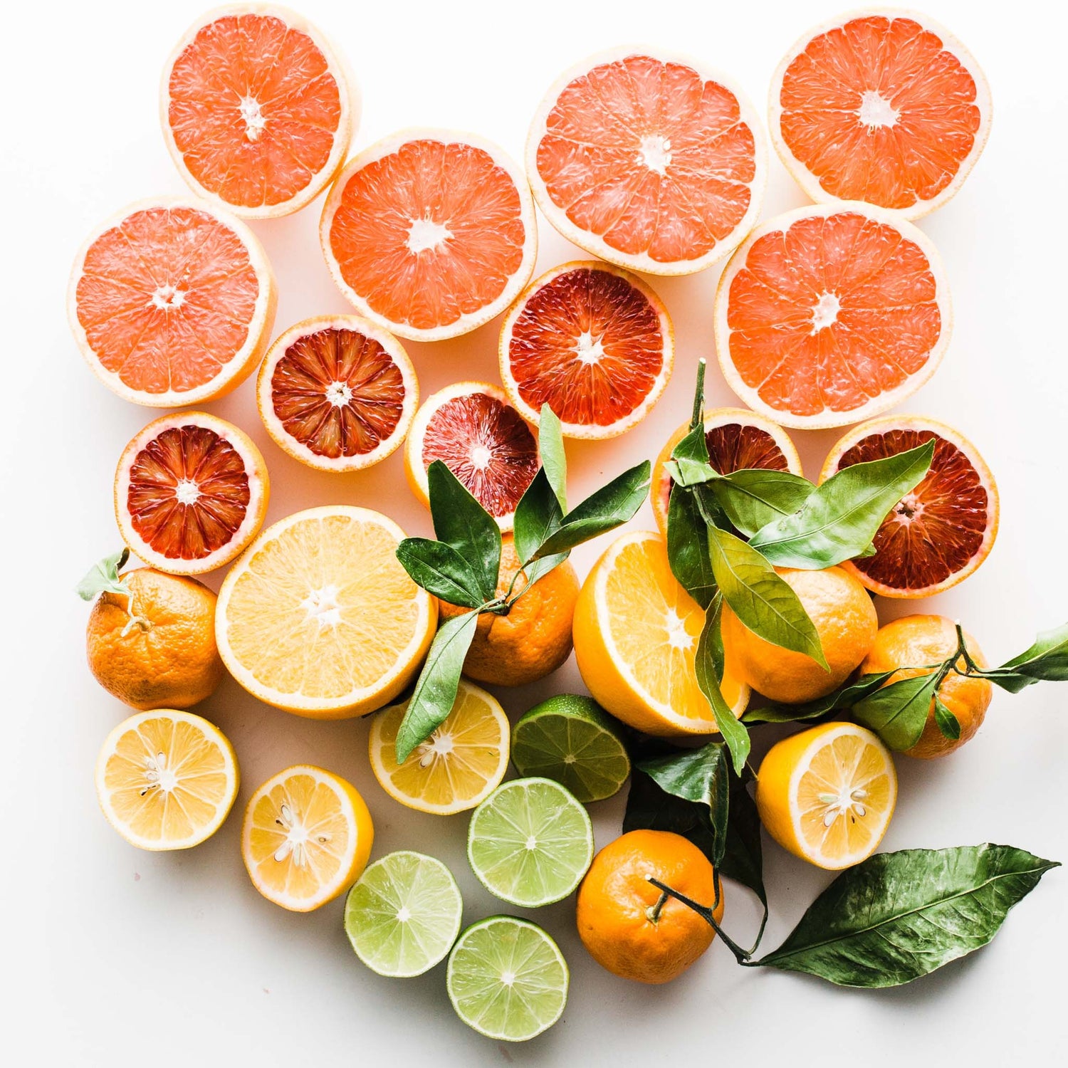 Fresh sliced lemons, limes, oranges, and grapefruits.