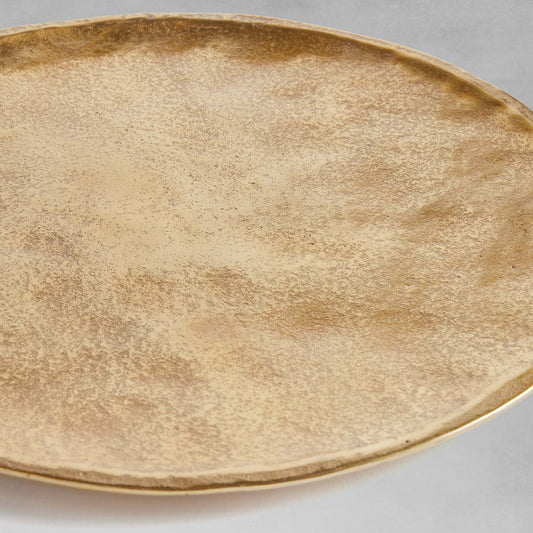 Gold round decorative tray, angled view, with gray background.