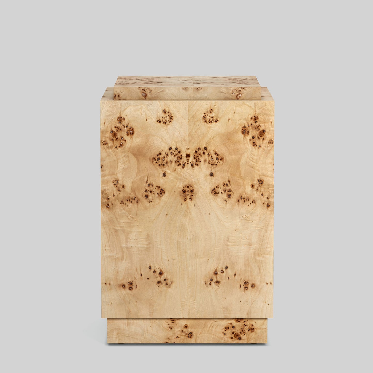 Light burl wood plinth side table on gray background.