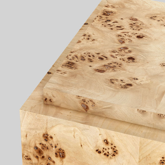 Light burl wood plinth side table on gray background.