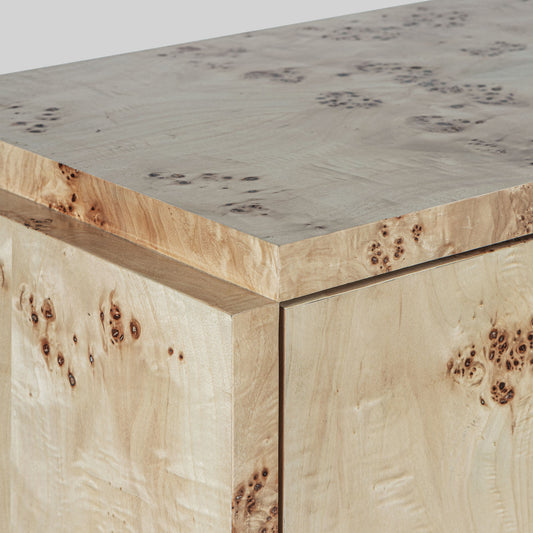 Light burl wood sideboard table on gray background.