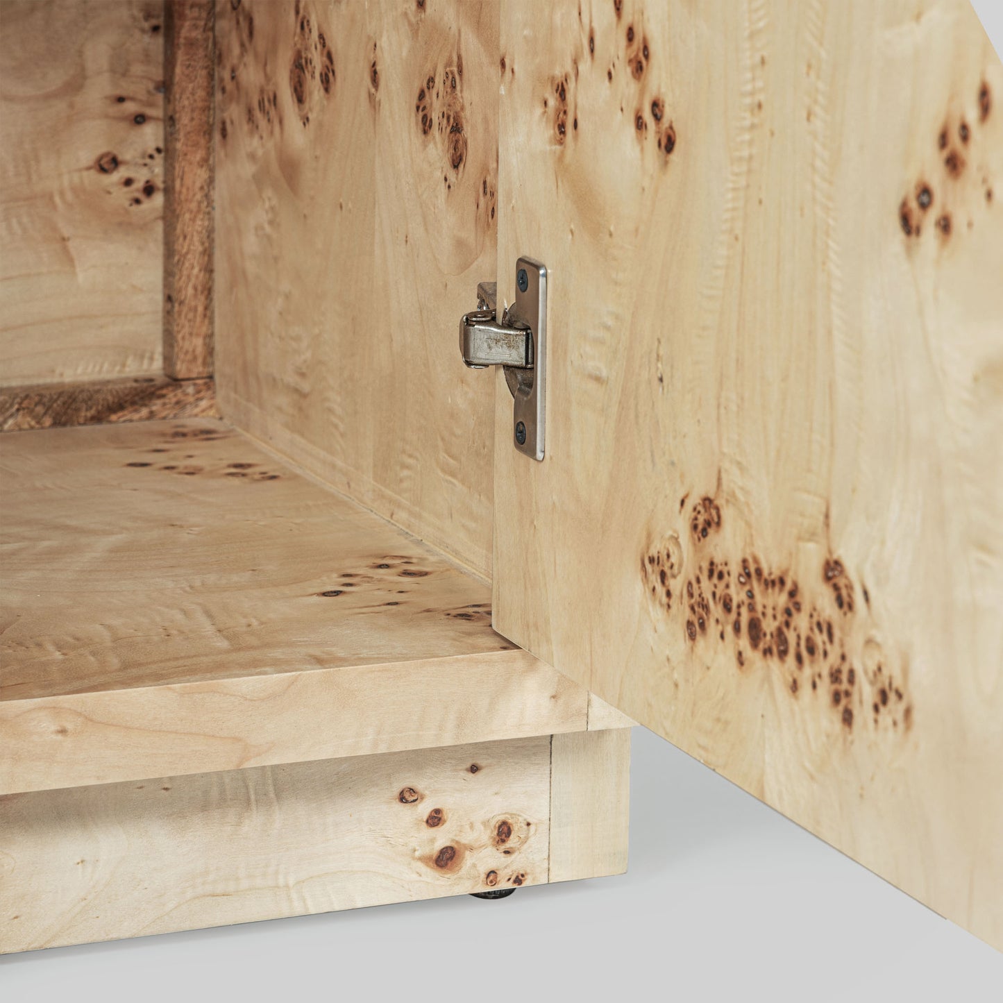 Light burl wood sideboard table on gray background.
