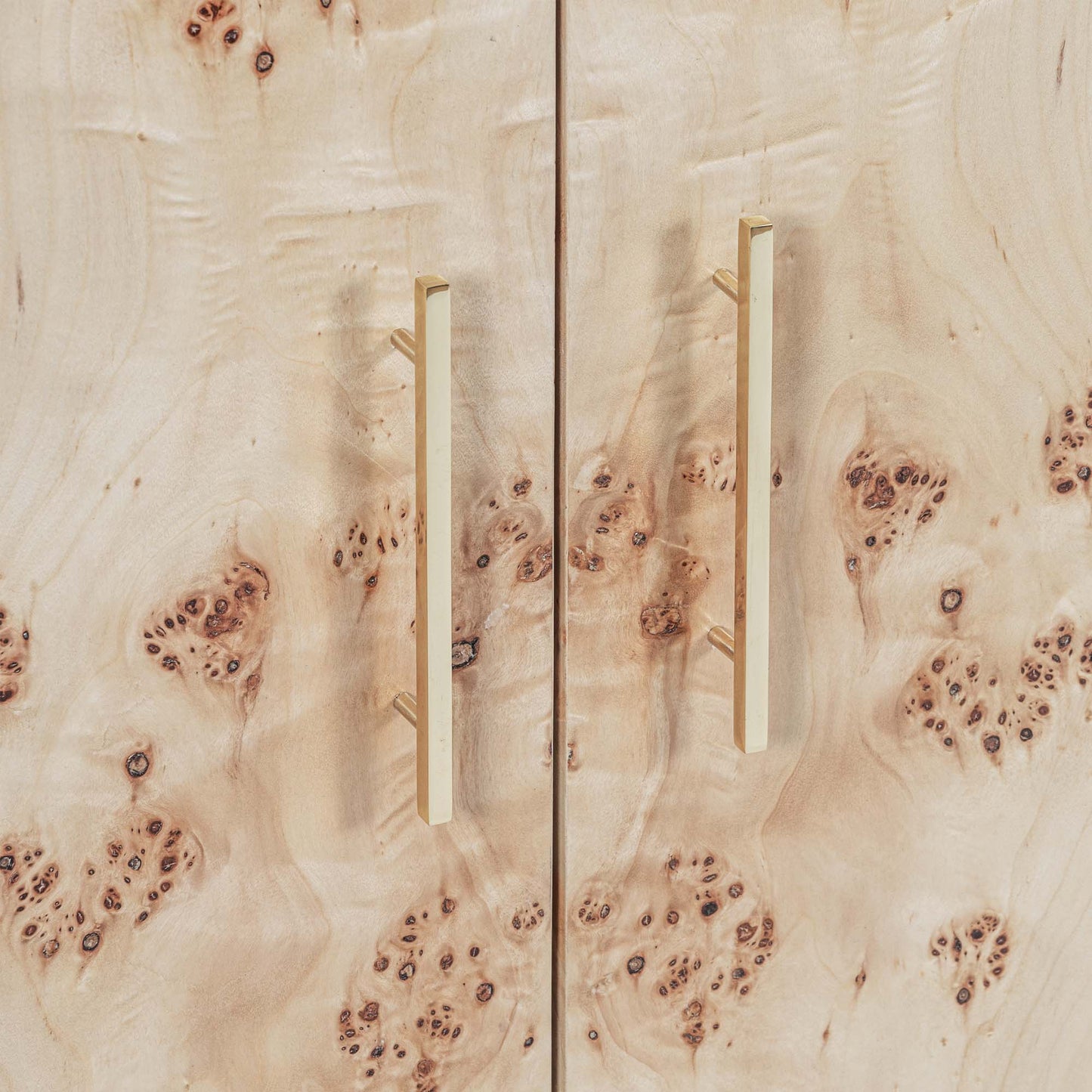 Light burl wood sideboard table on gray background.