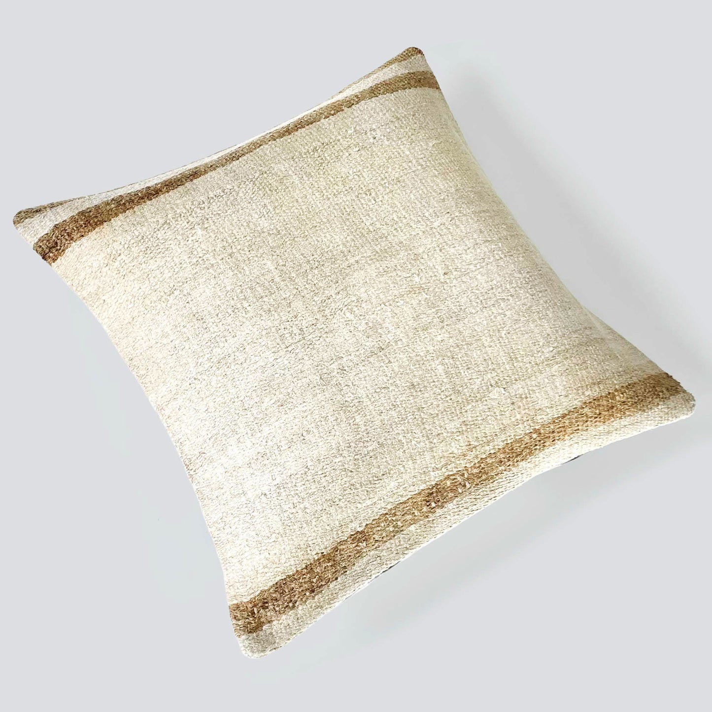 Handwoven Turkish kilim hemp pillow cover in sand with light caramel stripes.