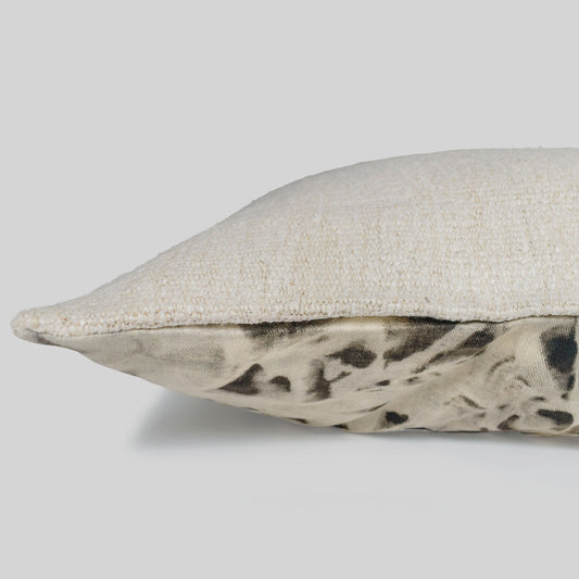 Textured pillow with a natural pattern on a gray background.