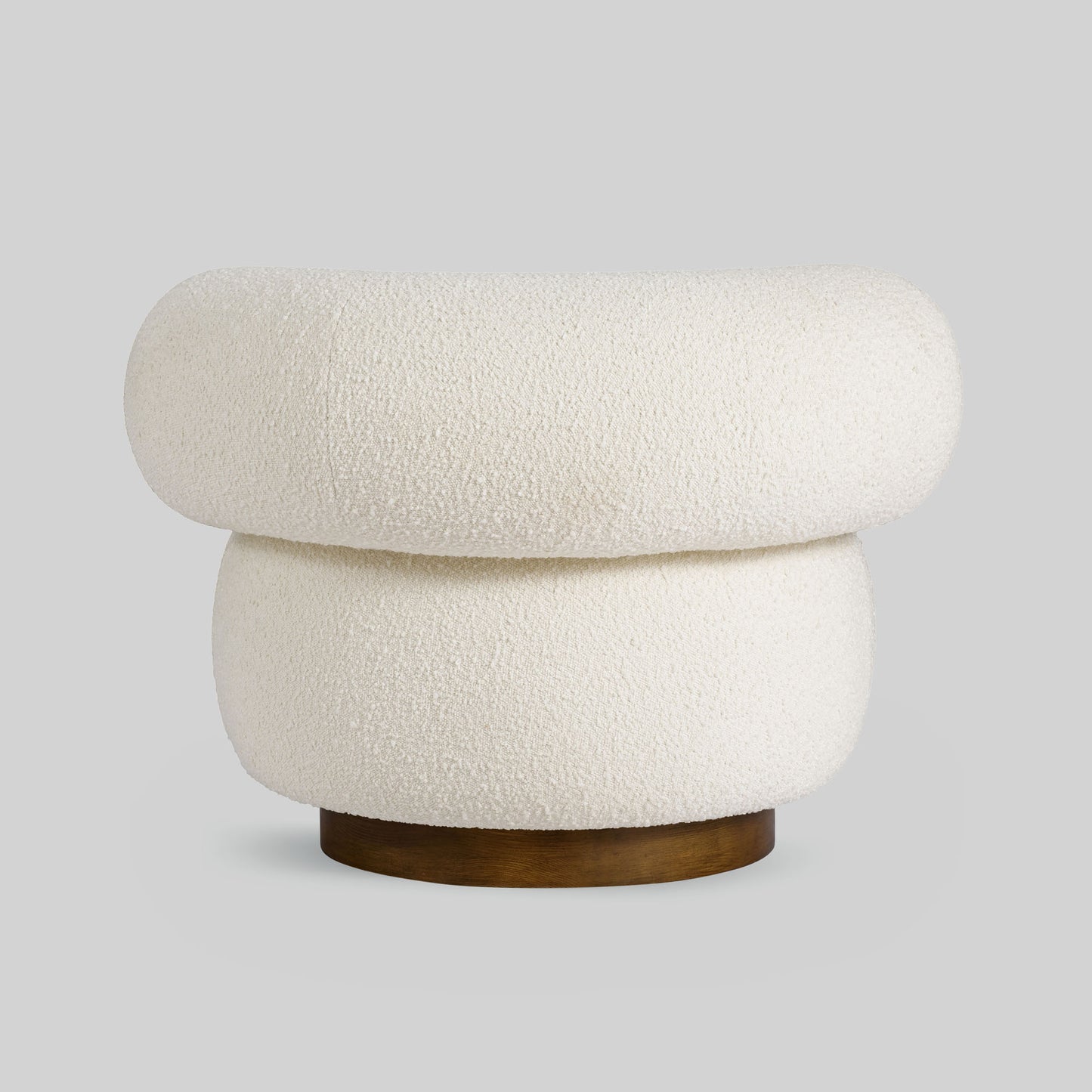 Light colored boucle fabric swivel chair on gray background.
