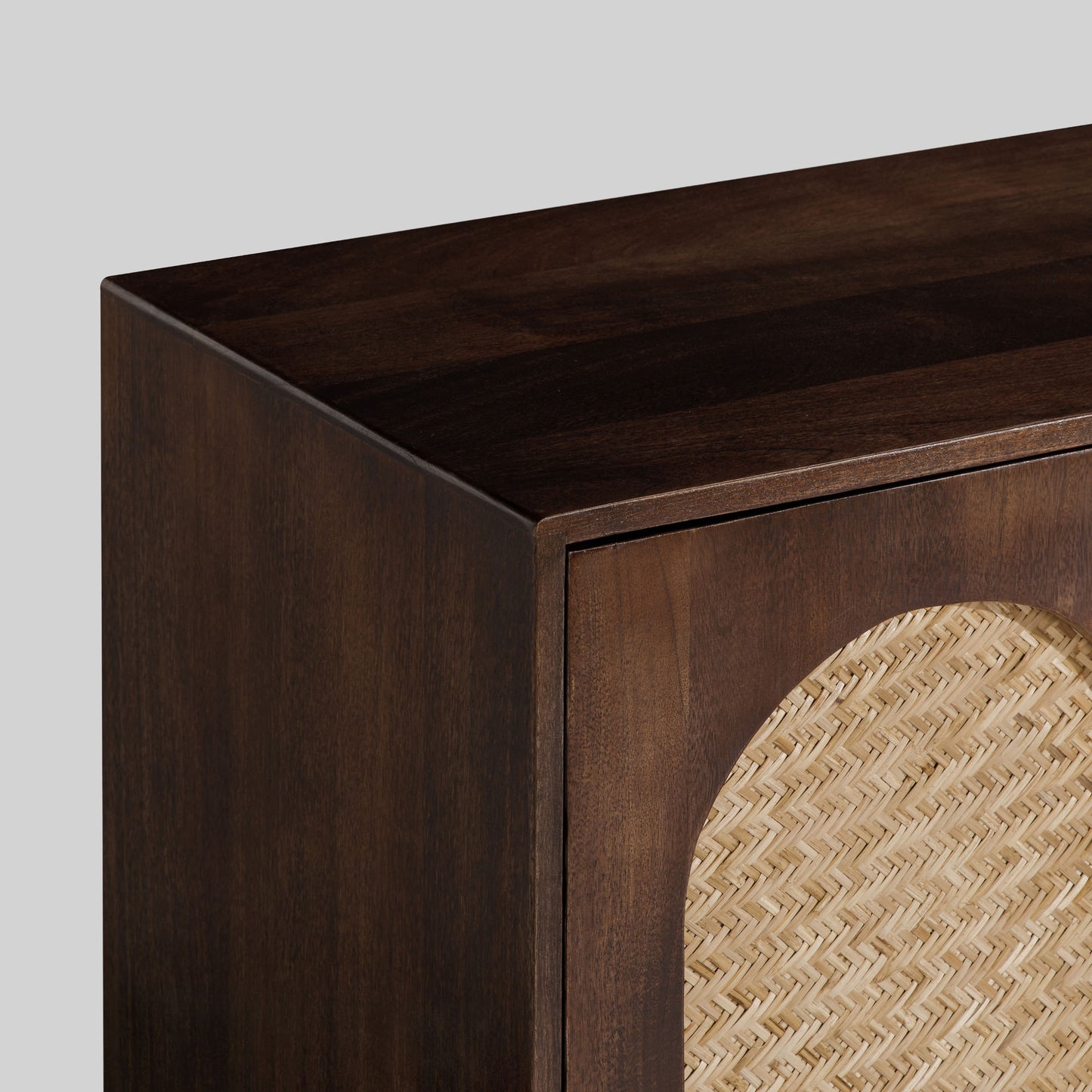 Wooden sideboard with four arched doors featuring a textured rattan design on a gray background.