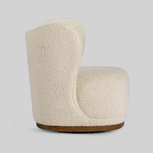 Cream toned sherpa fabric textured lounge chair on gray background.