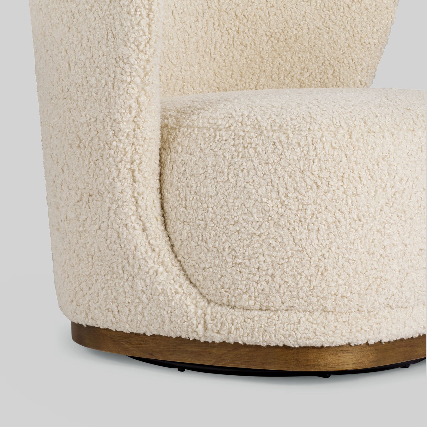 Cream toned sherpa fabric textured lounge chair on gray background.