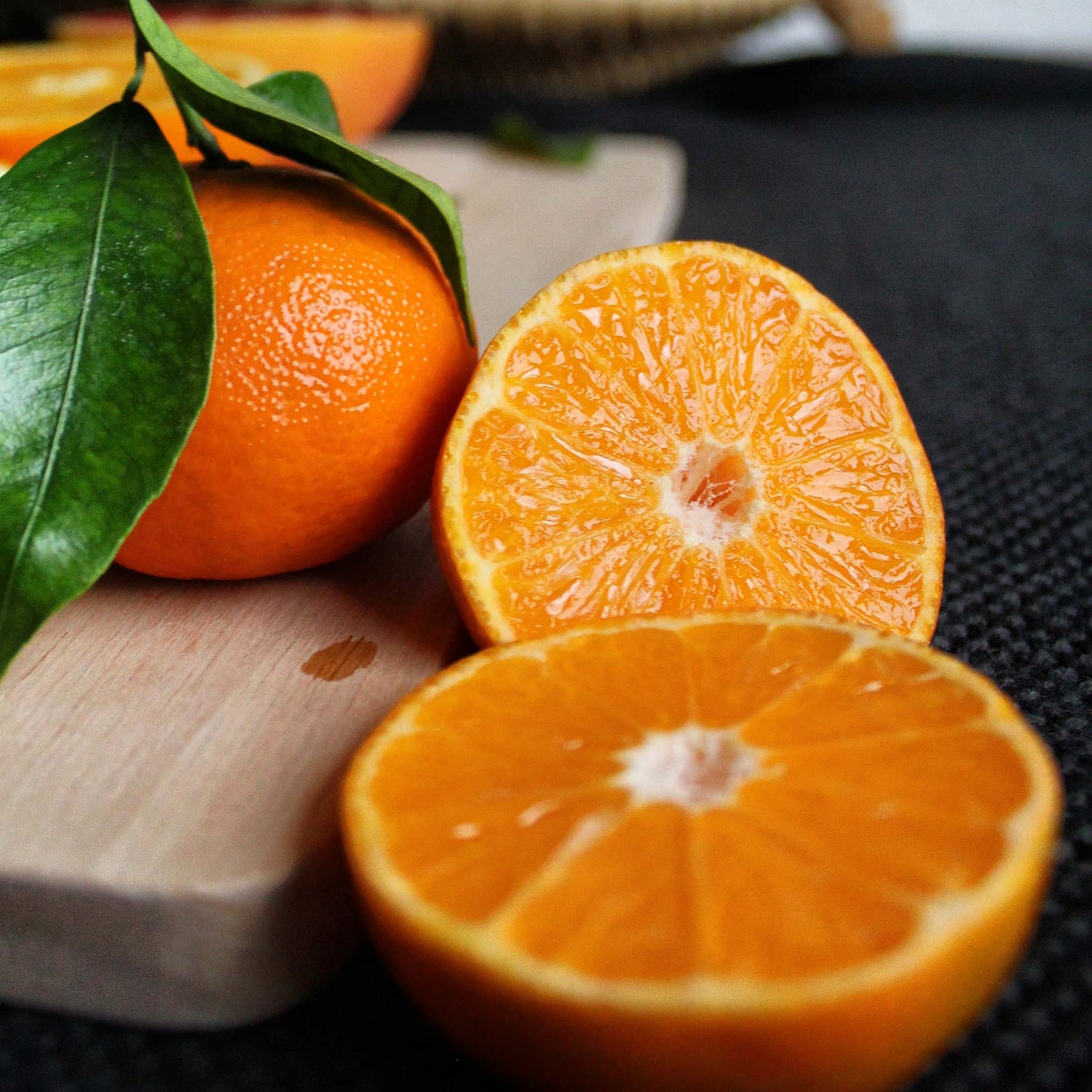 Sliced mandarins on cutting board.