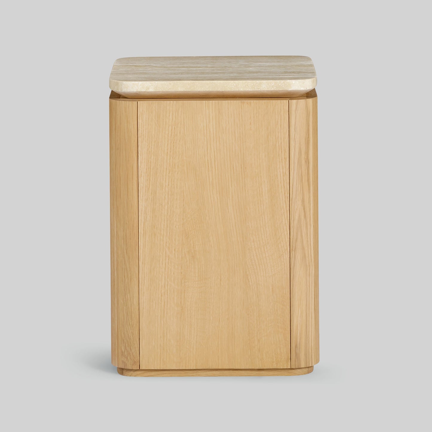 Wooden side table with a light oak finish and travertine top on a gray background.
