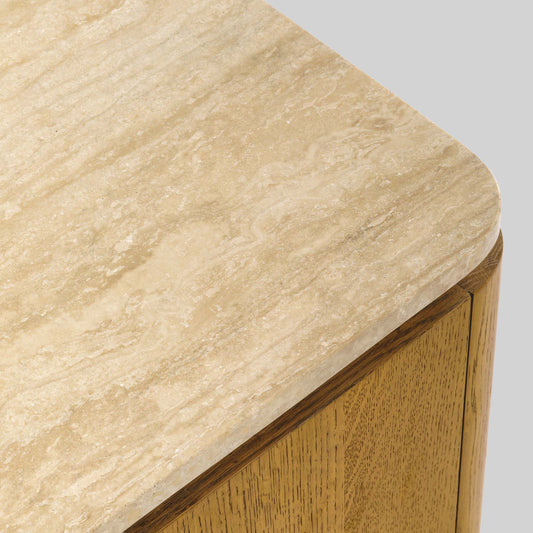 Wooden side table with a light finish and travertine top on a gray background.
